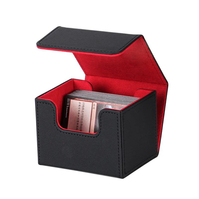 Open black trading card deck box with red interior holding a stack of trading cards.
