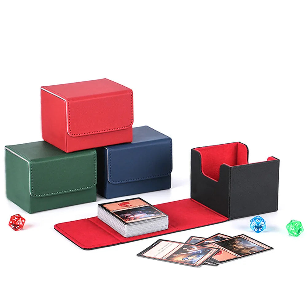 Red, green and navy deck boxes beside an open black-and-red box, trading cards and dice.